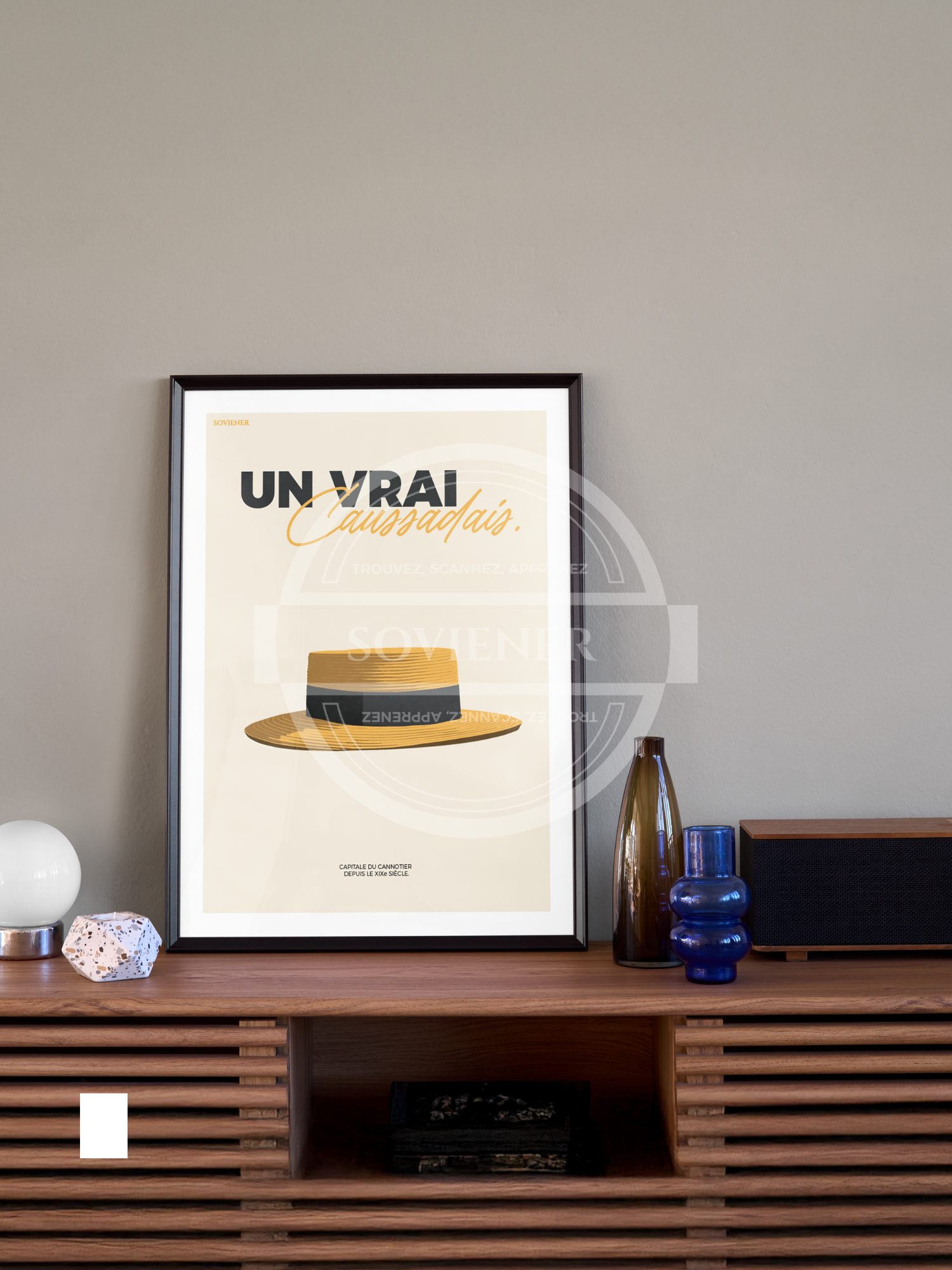 Illustration vintage minimaliste d'un chapeau canotier de paille sur fond crème, texte "Un Vrai Caussadais" en noir et jaune, affiche hommage à l'artisanat de Caussade, imprimée à Montauban sur papier 350g.